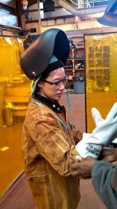 Amy Batallones, FCLC ’13, suits up in welding gear to do mechanical work at one of Con Edison’s steam-generating stations. 