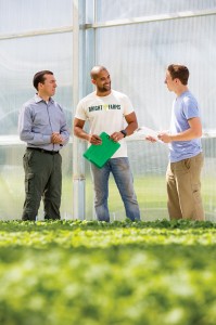 From left: BrightFarms' CEO Paul Lightfoot with Carlos Mendez, head grower at the company's Pennsylvania greenhouse, and Dominick Mack, production manager. (Photo by Bud Glick)
