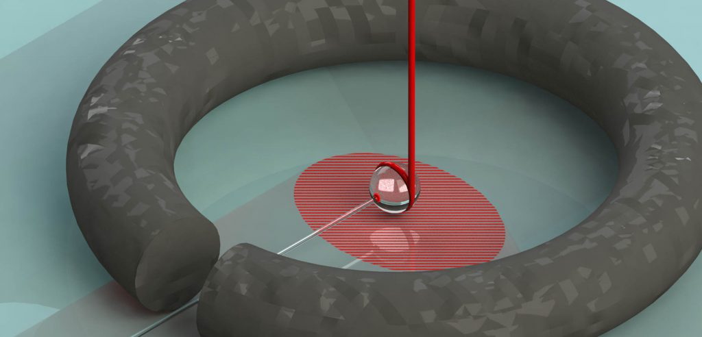 The light in the whispering gallery mode is represented as the ribbon around the perimeter. The leakage out that we monitor is depicted as the beam point up coming off the edge of the sphere.