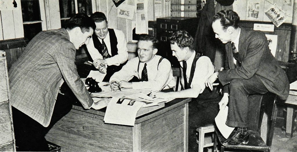 Editor-in-Chief Donovan (center) holds court with his fellow newsmen in the offices of The Ram. 