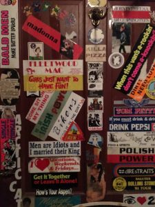 Vintage stickers cover the bathroom door.