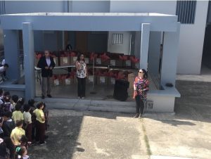 Aida Nevárez-La Torre, Ed.D., and Jacqueline Bocachica González, Ed.D. present boxes of school supplies to the students of Escuela Julio Alvarado Tricoche.