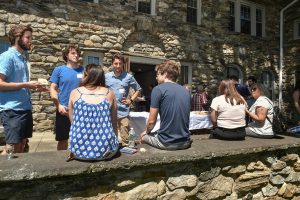 Students mingle on the front porch of Calder Hall