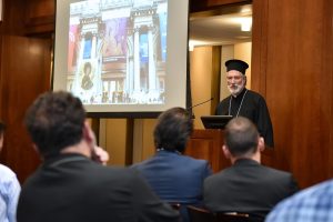 Bishop Irinej, Bishop of the Serbian Orthodox Diocese of Eastern America, speaking at the podium at the 12th floor lounge.
