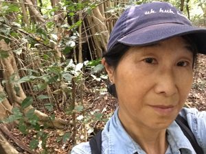 Reiko Matsuda Goodwin poses for a selfie in the forest.