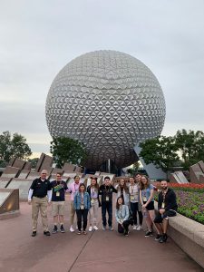 Gabelli students standing in front of the Epcot's Spaceship Earth ride 
