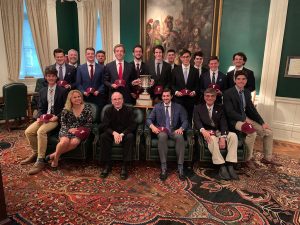 The crew team seated with Father McShane