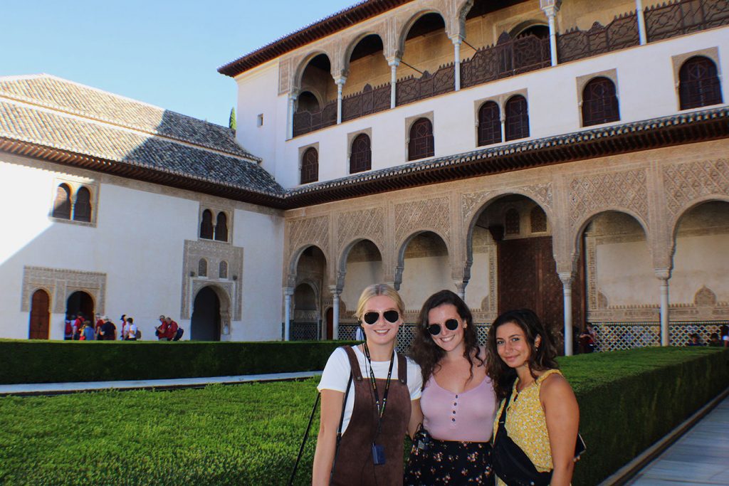 women standing in front of a villa in Granada