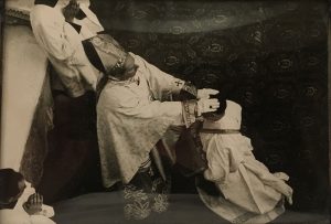 priest with a hands being laid on his head
