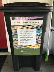 A black of books with the sticker "BOOK DONATION BIN"