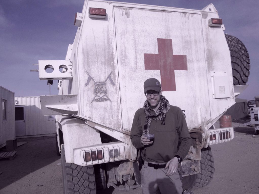 Ray Mitchell standing in front of a Red Cross truck