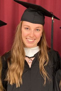 Anne-Sophie Neumeister wearing cap and gown at Fordham's graduation.